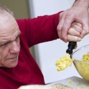 Man being helped to eat