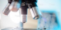 Side view of a microscope above a slide