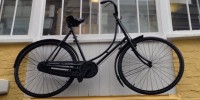 Old fashioned bicycle leant against a window