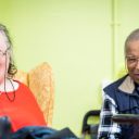 Two happy looking people in a care home setting